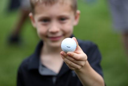 Young fan with a golf ball from Tiger Woods